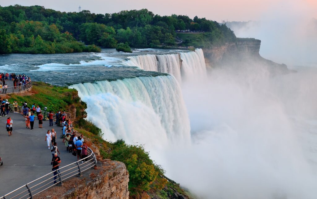 Visitors watch Niagara Falls from a viewpoint, one of Canada's most famous tourist destinations.