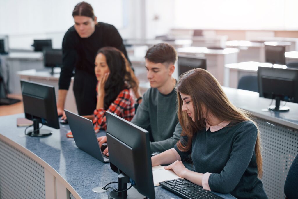 Students in a computer room programming in computers, representing the extracurricular programming activity at Fredericton Christian Academy.