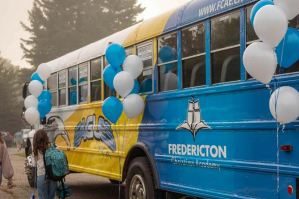 School bus decorated with balloons, symbolizing school transportation and transfer services for students in Fredericton, Canada.